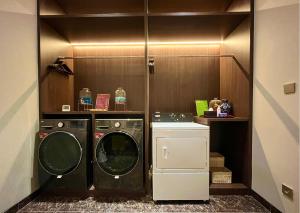 a laundry room with a washer and dryer at Ashley Tang Menteng Jakarta in Jakarta