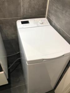 a white refrigerator sitting in a bathroom next to a wall at Sea View Riviera- 4 bed apartment in Riviera del Sol with beautiful sea view! in La Cala de Mijas