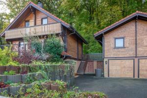 a house with a garage in front of it at Chalet Café-Chocolat in Waldighofen