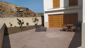 een patio met 2 stoelen en een tafel en een gebouw bij Casa de Playa Sol Y Mar in El Médano