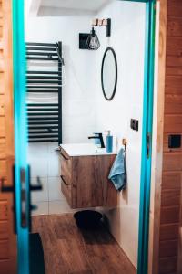 a bathroom with a sink and a mirror at Dychnij Se in Szczyrk