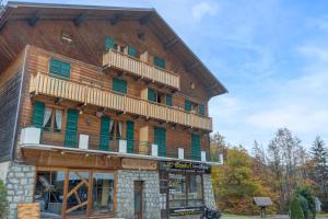a large wooden building with a balcony on it at Lou Darbelots in La Giettaz