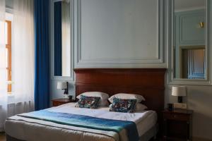 Postel nebo postele na pokoji v ubytování Leopolis Hotel