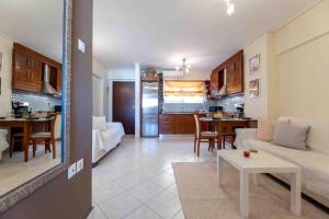 a living room and kitchen with a couch and a table at Peristeri 2 BD flat next to metro Agios Antonios in Athens
