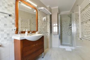 a bathroom with a sink and a shower at AGO Apartments in Bucharest +15 photos