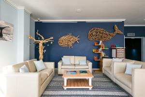 a living room with two couches and a table at Zzzone Boutique Hostel in Hermanus