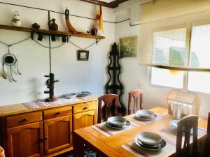 a kitchen with a wooden table with plates on it at Piso Alicante in Alicante