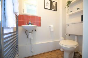 a bathroom with a toilet and a sink at Badger's Rest-parking included, lockable rooms 