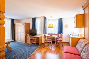 a living room with a kitchen and a dining room at Dietrich Comfort Appartements in Telfs