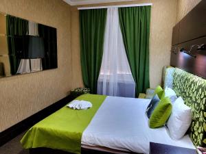 a hotel room with a bed and a window at Maxim Pasha Hotel in Chişinău