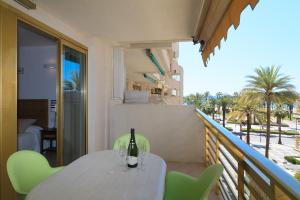 a table with a bottle of wine on a balcony at UHC Novelty Apartments in Salou