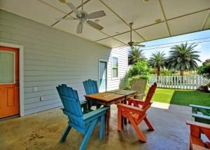 a patio with three chairs and a wooden table at Beach Club 1 in Port Aransas