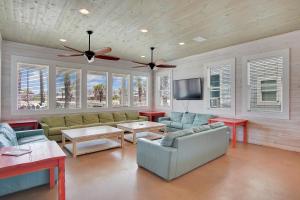 a living room with couches and a flat screen tv at Beach Club 1 in Port Aransas