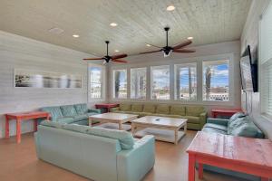 a living room with couches and a ceiling fan at Beach Club 1 in Port Aransas