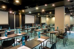 a conference room with tables and chairs with water bottles at SANA Berlin Hotel in Berlin