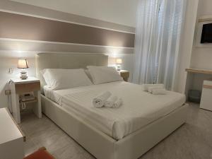 Postel nebo postele na pokoji v ubytování Porto Cesareo Hotel