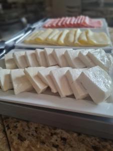 a tray of cheese and other foods on a table at Pousada Casa dos Contos in Ouro Preto