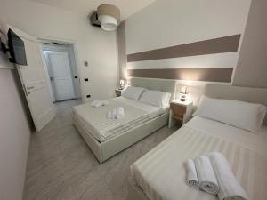 Postel nebo postele na pokoji v ubytování Porto Cesareo Hotel