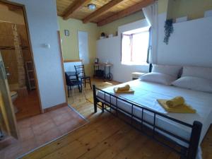 a bedroom with a bed and a living room at Apartments Elena & Damir in Vis