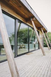 uma casa com janelas de vidro e um deque de madeira em Yorkshire Dales Lodge 7 Premium Ensuite em Richmond