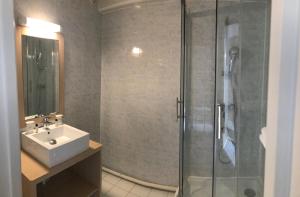 a bathroom with a glass shower and a sink at The Originals City, Hôtel Villancourt, Grenoble Sud in Le Pont-de-Claix +44 photos