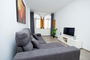 a living room with a couch and a tv at El Charco I - By AZ Rentals in Arrecife