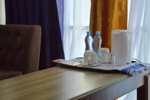 a table with a tray with two glass bottles on it at Montana Guest Resort Naivasha in Naivasha