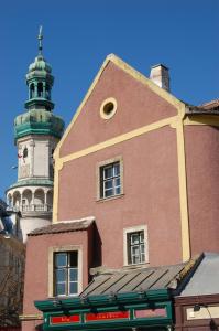 a building with a lighthouse on top of it at Belváros Apartmanház Sopron in Sopron