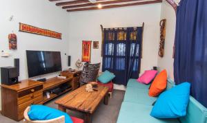 a living room with a blue couch and a television at Majani Breeze in Nungwi