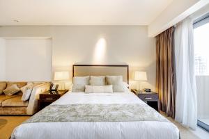 una camera con un grande letto e un divano di Studio Marina View Access to Marina Mall a Dubai