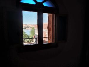 an open window with a view of a river at Labib Guest House in Aswan
