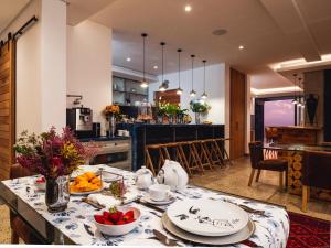 a kitchen and dining room with a table with food at Boutique Ocean Views - incorporating Wendy's in Hermanus