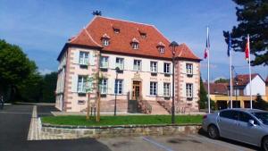 un gran edificio blanco con techo rojo en Maison de 3 chambres avec terrasse amenagee et wifi a Ingersheim, en Ingersheim