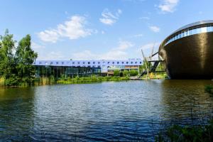 a building with a bridge over a body of water at Atlantic Hotel Universum in Bremen