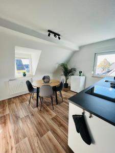 a kitchen and dining room with a table and chairs at Himmlische Weite 3 in Schweinfurt +23 photos