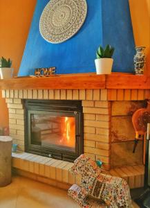 a living room with a fireplace with a tv at A Casiña do Patio in Quiroga