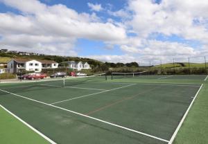 a tennis court with a net on top of it at SPACIOUS DETACHED 5 Bedroom4 Bathroom WIFI Parking in Newcastle under Lyme