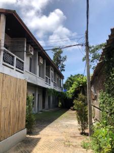 an old building with a gate and a fence at Beach Way Apartment in Koh Samui