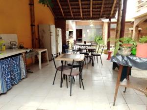 a restaurant with tables and chairs in a room at Posada Los Arcos in Villa Cura Brochero