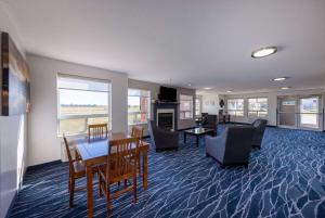 a living room with a table and chairs and a dining room at Super 8 by Wyndham Jackson MN in Jackson