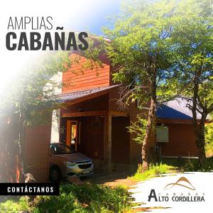 a house with a car parked in front of it at Cabañas Alto Cordillera in Las Trancas