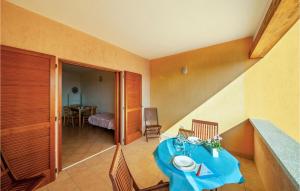 a room with a table with a blue table cloth at 1 Bedroom Beautiful Apartment In Isola Rossa in Isola Rossa