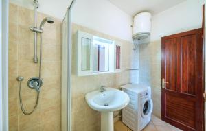 a bathroom with a sink and a shower at 1 Bedroom Beautiful Apartment In Isola Rossa in Isola Rossa