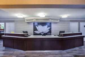 a lobby with a reception desk with a flower on the wall at La Quinta Inn by Wyndham Laredo I-35 in Laredo