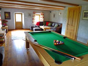 a living room with a pool table in it at Osada Jeździecka Bata in Mirsk