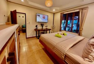a hotel room with a bed and a window at Three rare & private front beach villas in Thong Sala