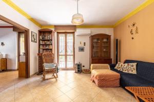 un soggiorno con divano blu e sedia di Appartamento con Ampia Terrazza - 10 minuti da Torino a Moncalieri