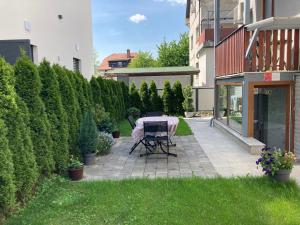 a patio with a table in the middle of a yard at Boutique Apartments in Ljubljana +15 photos