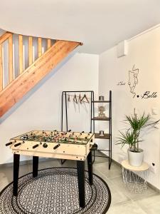 a chess board on a table in a room with a staircase at Maison 2 Chambres - TV - CLIM - BABY FOOT in Ruelle-sur-Touvre