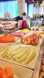 a counter topped with lots of different types of fruit at Carmel Express in Fortaleza